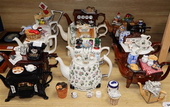 A collection of thirteen Portmeirion and Cardew novelty teapots, including dresser, sewing machine and kitchen range examples